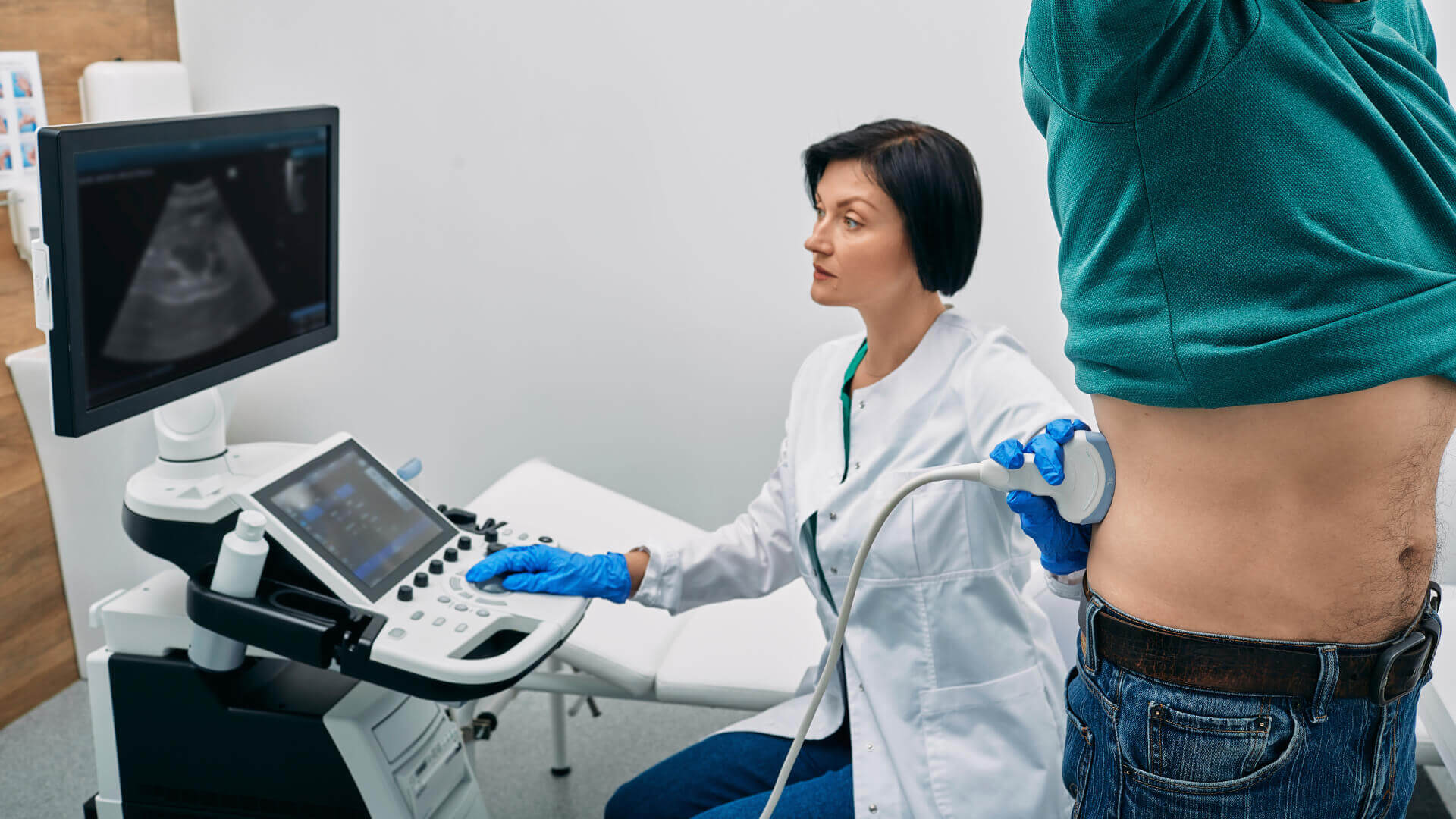 nephrologist scanning a patient for kidney stones